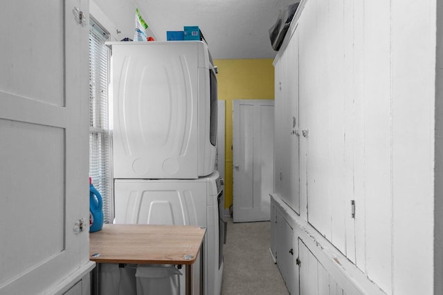 laundry area with stacked washing maching and dryer