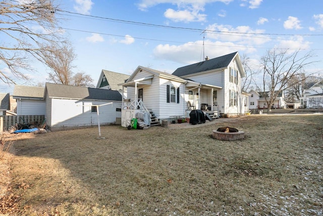 view of property exterior featuring a lawn and a fire pit