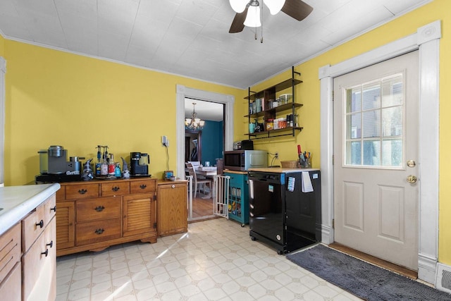 kitchen featuring ornamental molding, black dishwasher, and ceiling fan with notable chandelier