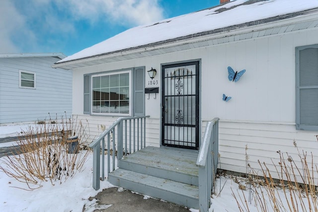 view of snow covered property entrance