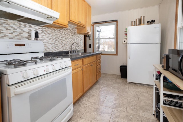 kitchen featuring tasteful backsplash, white appliances, and sink