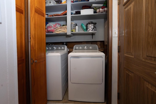 washroom with washing machine and clothes dryer