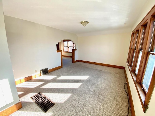 spare room featuring light colored carpet