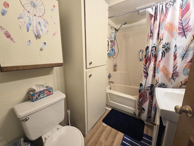 full bathroom featuring wood-type flooring, toilet, vanity, and shower / bath combo