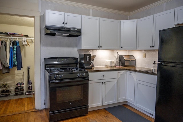 kitchen with white cabinetry, light wood-type flooring, and black appliances