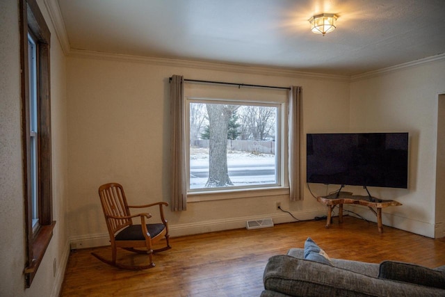 living room with crown molding and hardwood / wood-style floors