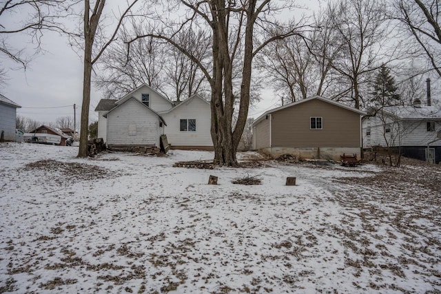 view of snow covered back of property