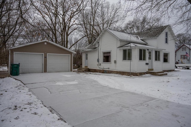 view of front of property featuring a garage and an outbuilding