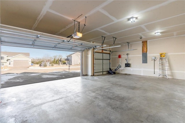 garage featuring a garage door opener and electric panel