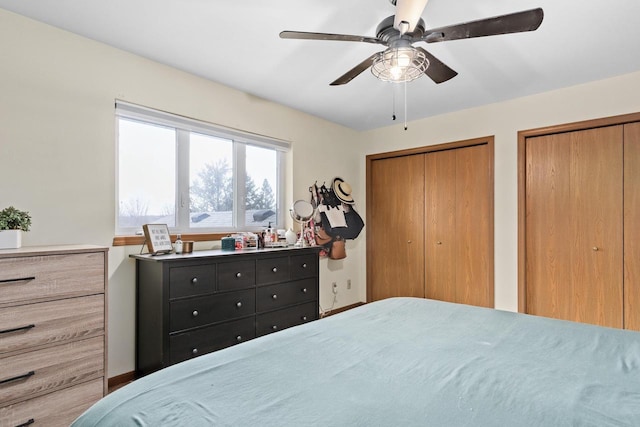 bedroom featuring ceiling fan and multiple closets