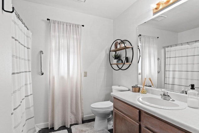 bathroom featuring vanity and toilet