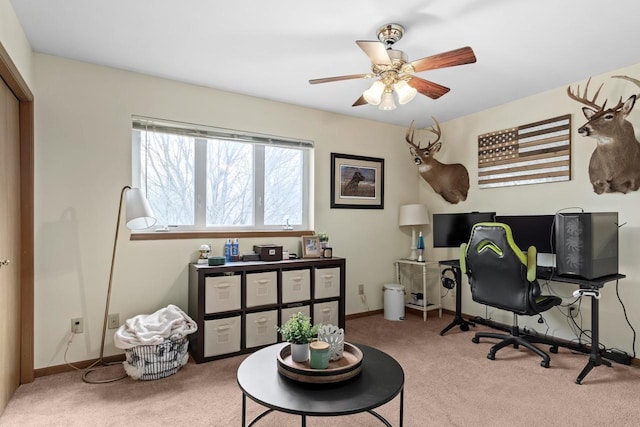 home office featuring ceiling fan and light carpet