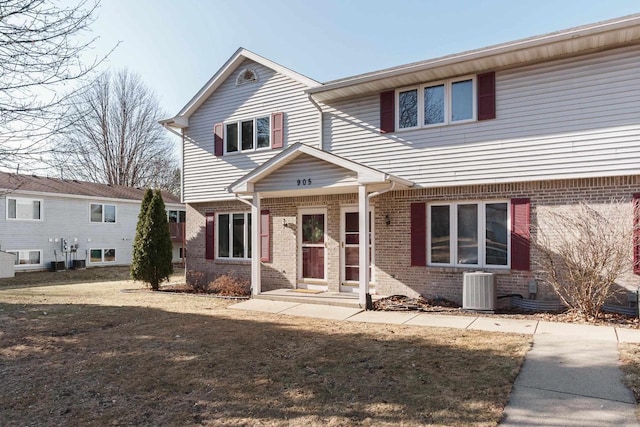 view of front facade with central AC unit and a front lawn