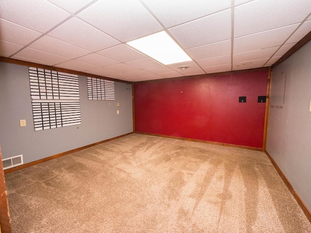 basement featuring carpet flooring and a drop ceiling