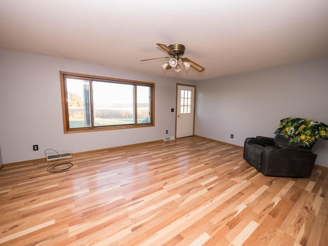 sitting room featuring ceiling fan and light wood-type flooring