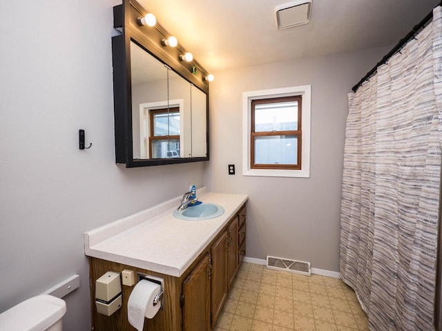 bathroom featuring vanity and toilet