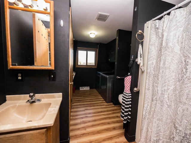 bathroom with hardwood / wood-style flooring and vanity