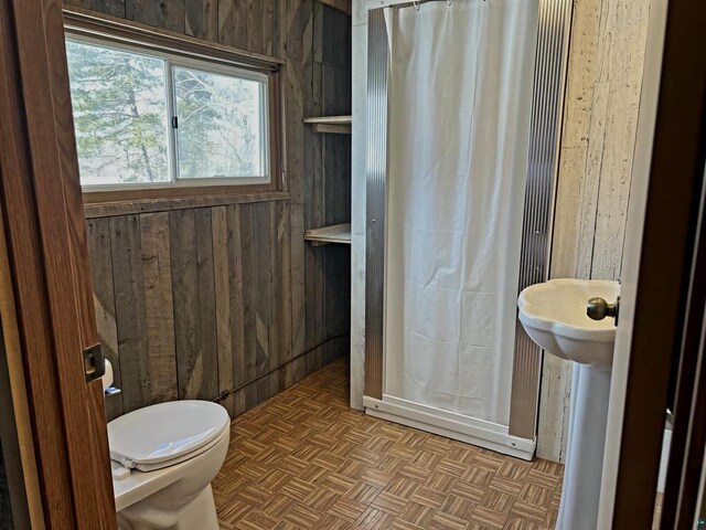 13770 State Highway 13, Herbster, WI 54844 - bathroom featuring parquet flooring, wooden walls, and toilet
