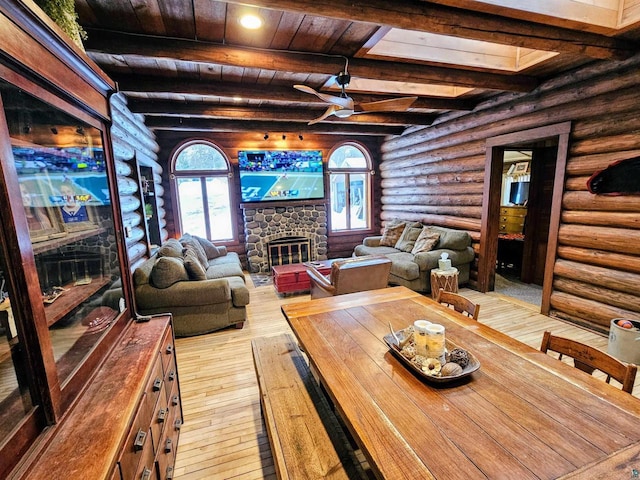 13770 State Highway 13, Herbster, WI 54844 - living room featuring ceiling fan, light hardwood / wood-style floors, a stone fireplace, wooden ceiling, and beamed ceiling