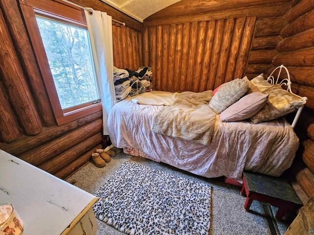 13770 State Highway 13, Herbster, WI 54844 - bedroom featuring vaulted ceiling and log walls