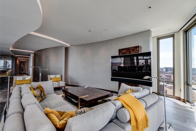 living room featuring expansive windows and light hardwood / wood-style floors