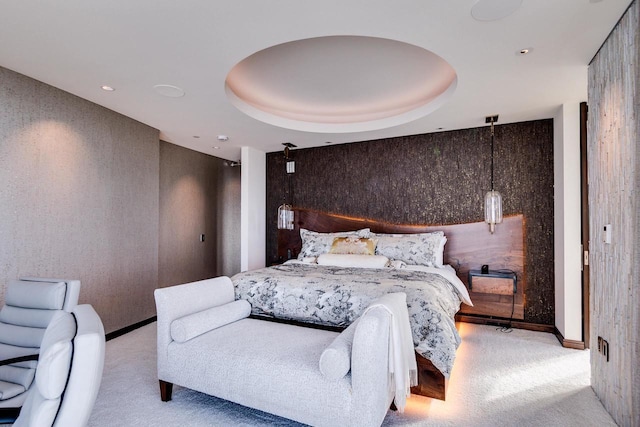 bedroom featuring light colored carpet and a tray ceiling