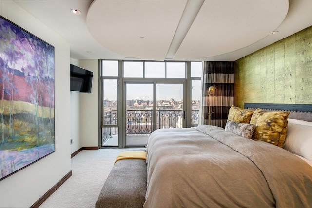 bedroom with access to exterior, expansive windows, and carpet flooring