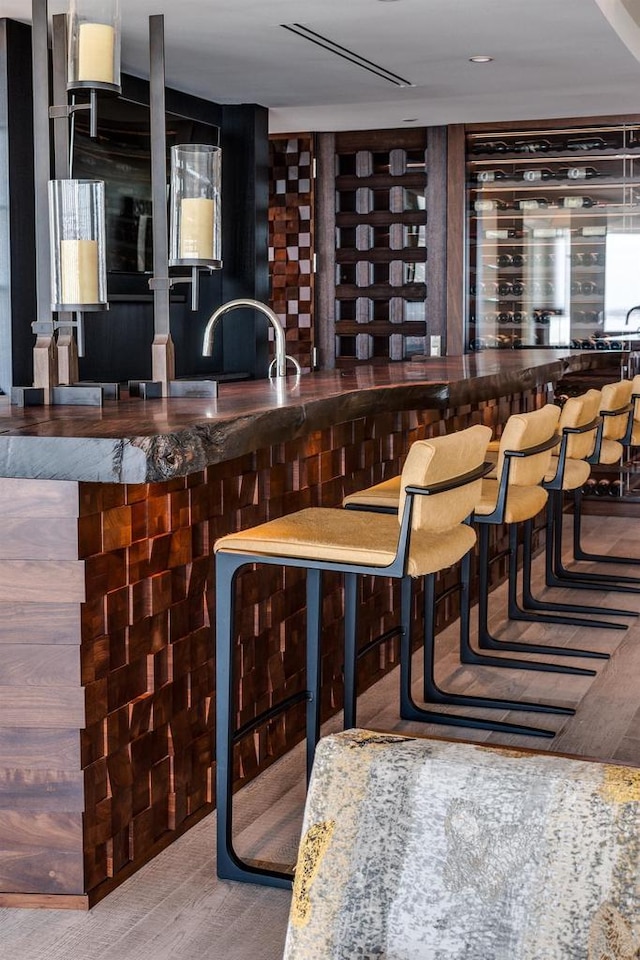 bar with hardwood / wood-style flooring