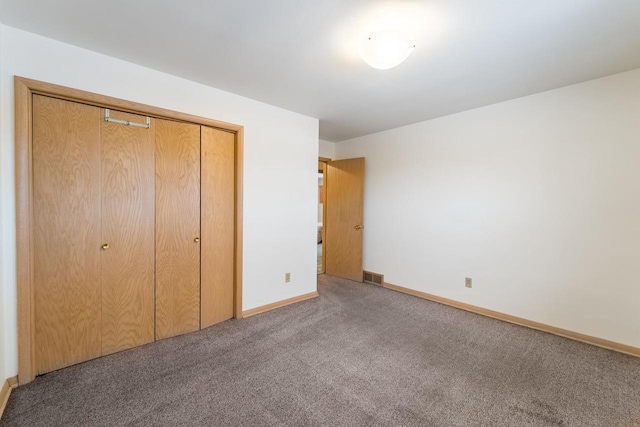 unfurnished bedroom featuring carpet floors and a closet