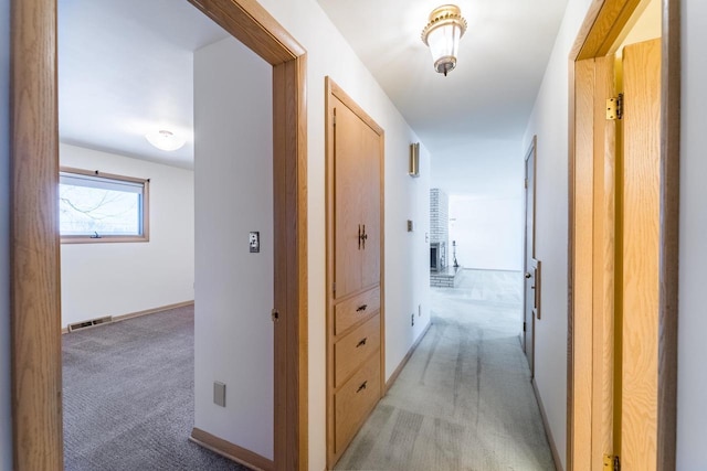 hallway with light colored carpet