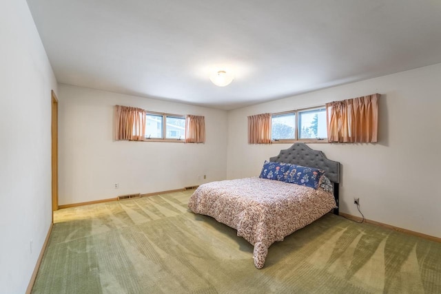 carpeted bedroom featuring multiple windows