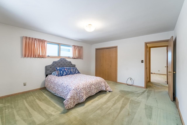 bedroom with light carpet and a closet