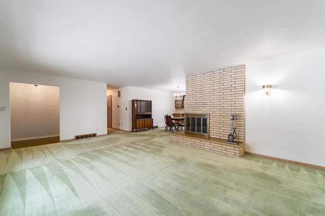 unfurnished living room with carpet floors and a notable chandelier