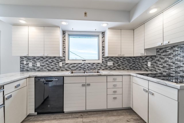 kitchen with tasteful backsplash, sink, black appliances, and white cabinets