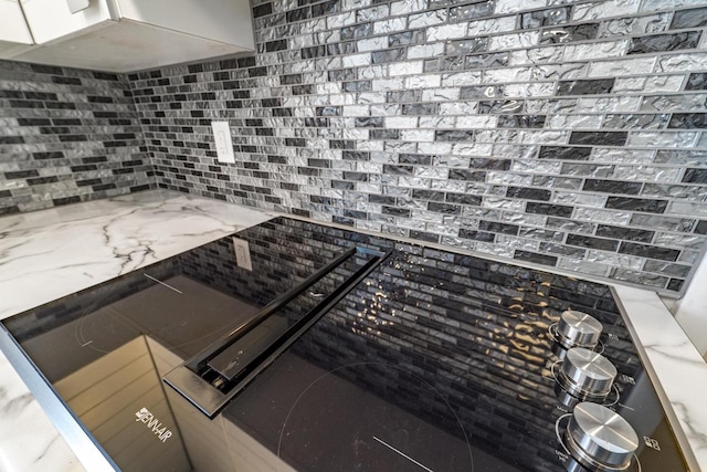 kitchen featuring light stone counters and decorative backsplash