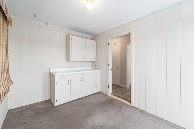 clothes washing area featuring light colored carpet