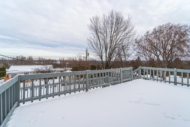 yard layered in snow with a wooden deck