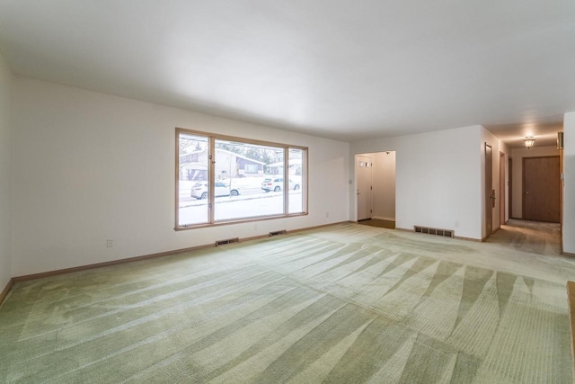 unfurnished living room featuring light carpet