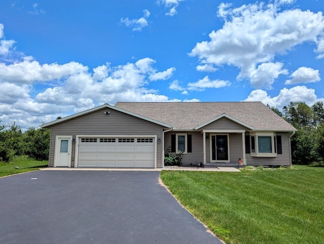 ranch-style house with a garage and a front lawn