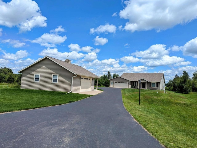 ranch-style home featuring a garage and a front lawn