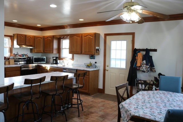 kitchen featuring sink, crown molding, a healthy amount of sunlight, and appliances with stainless steel finishes