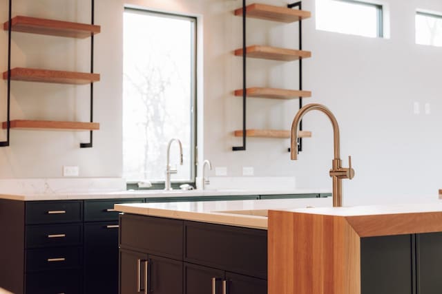 kitchen featuring light stone countertops and sink