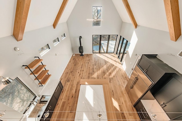 living room featuring high vaulted ceiling and beam ceiling