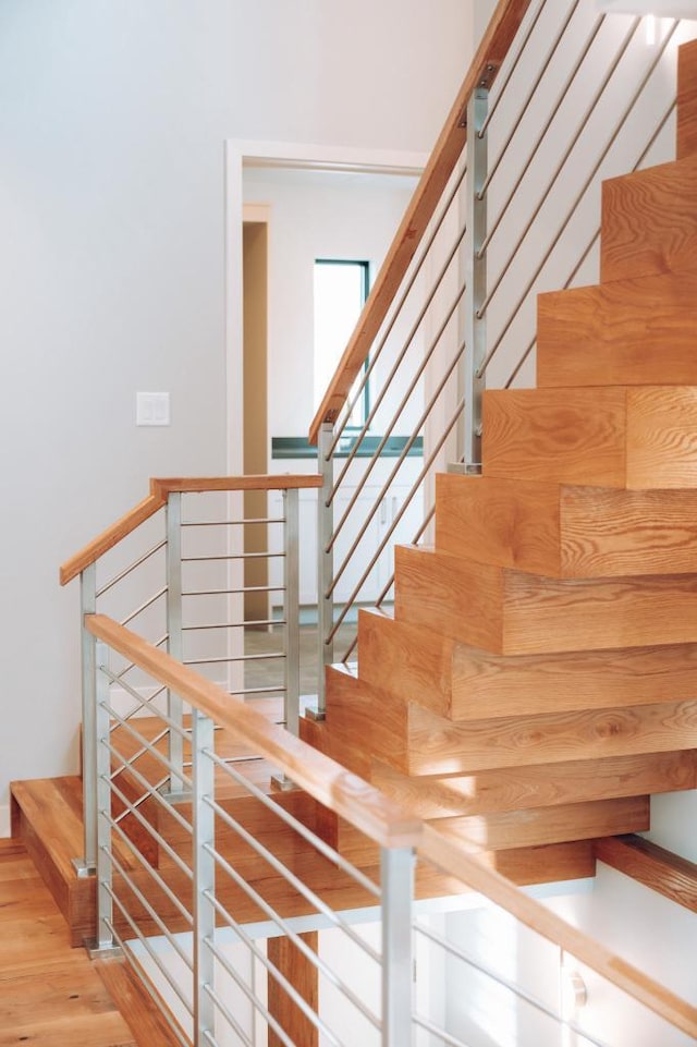 stairs featuring hardwood / wood-style floors