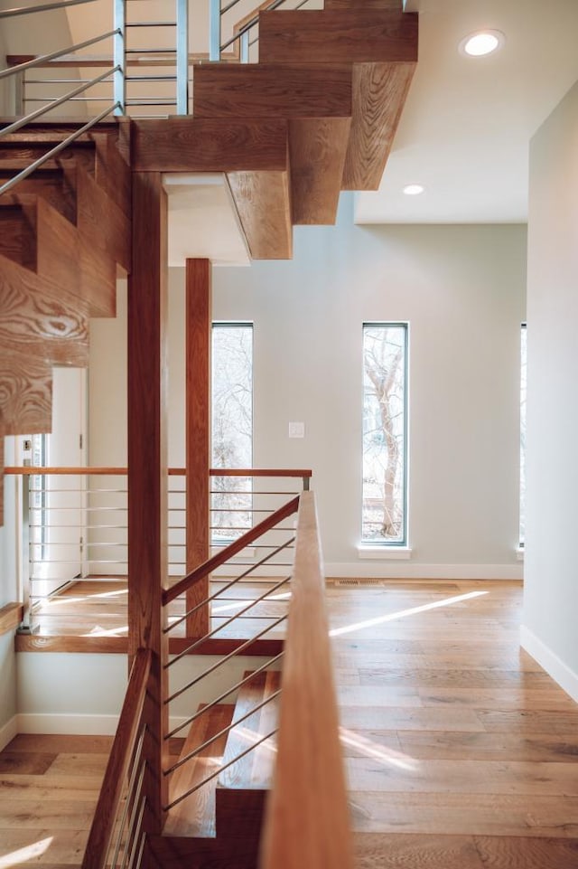 stairway featuring wood-type flooring