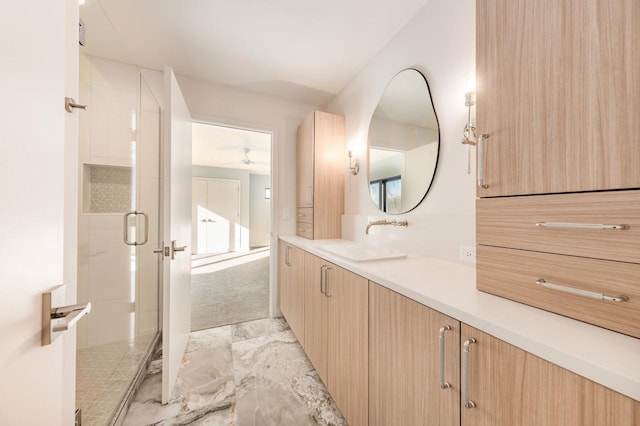 bathroom with vanity and a shower with shower door