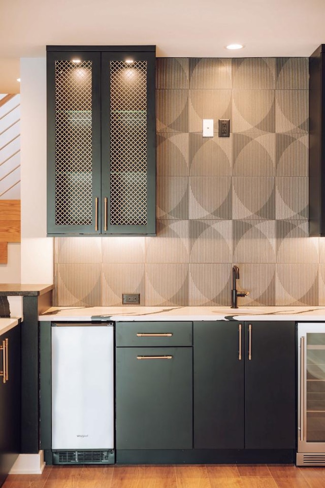 interior space with tasteful backsplash, fridge, and wine cooler