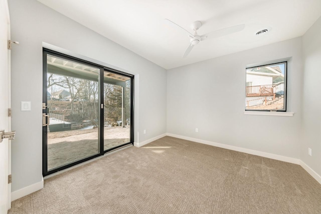 carpeted spare room featuring ceiling fan