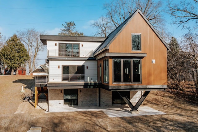 back of house with a patio and a balcony