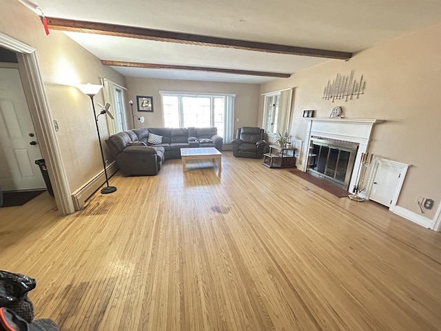 living room with beam ceiling, a baseboard heating unit, and light wood-type flooring